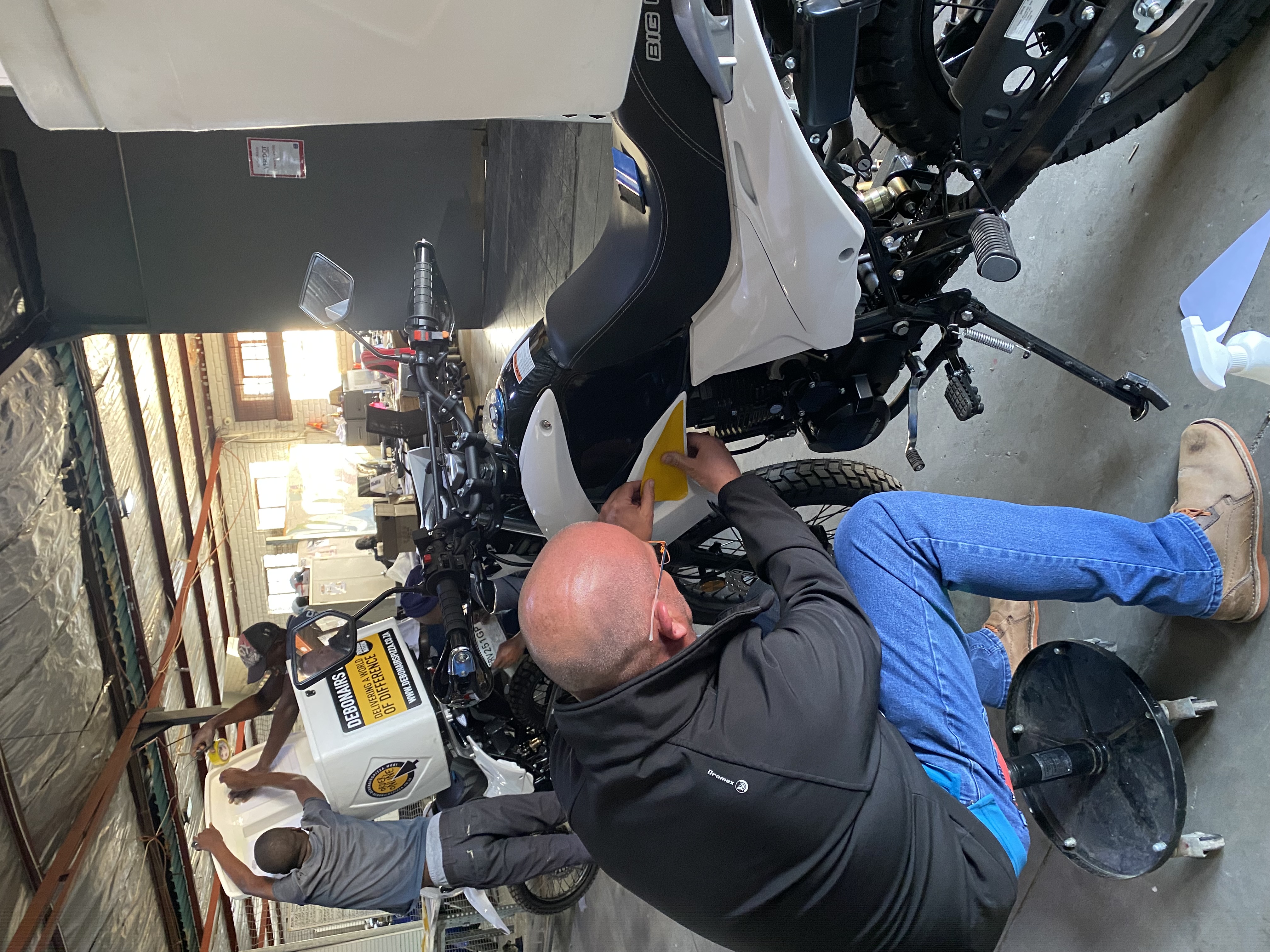 RoadLink technician servicing a fleet motorcycle