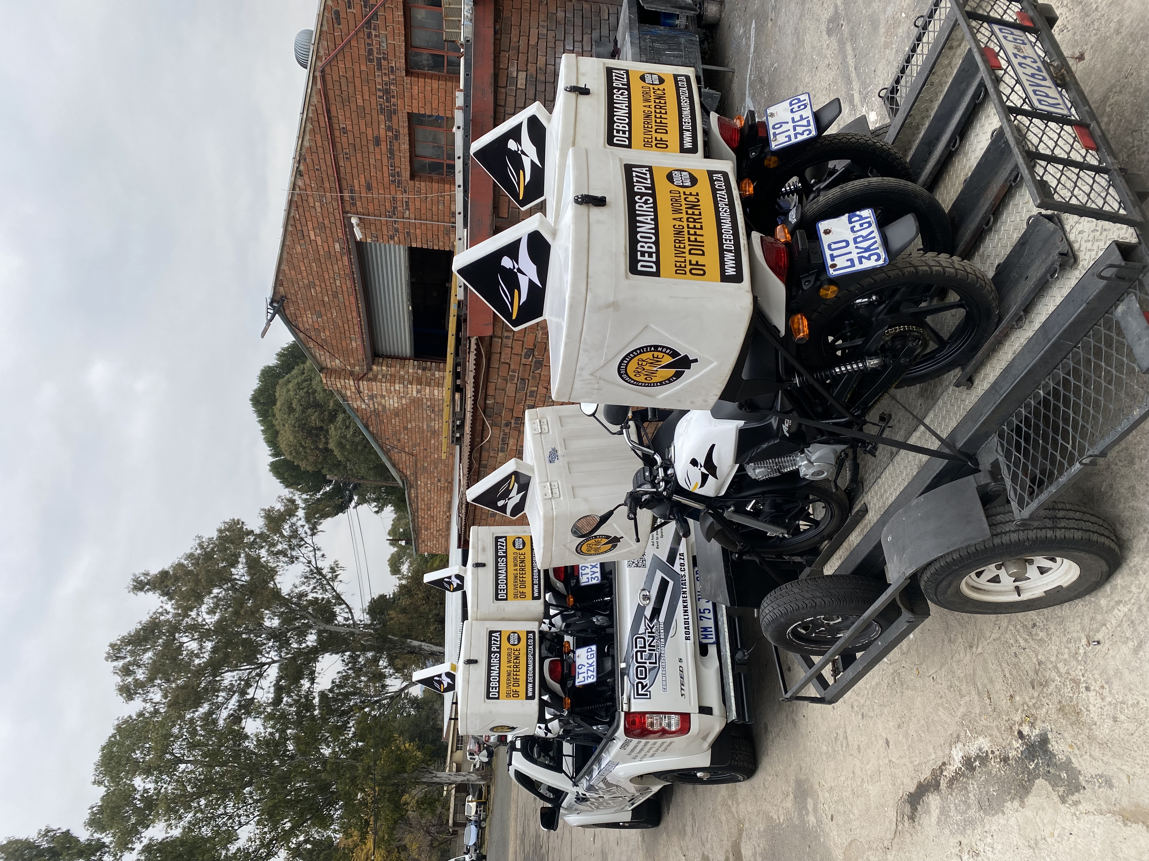 RoadLink fleet motorcycles loaded for delivery